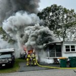 Plymouth firefighters battle a fire in a mobile home on Indian Trail on Monday.